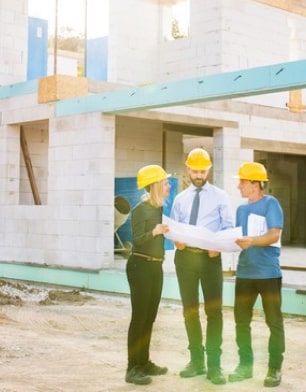 three people in the middle of a construction site